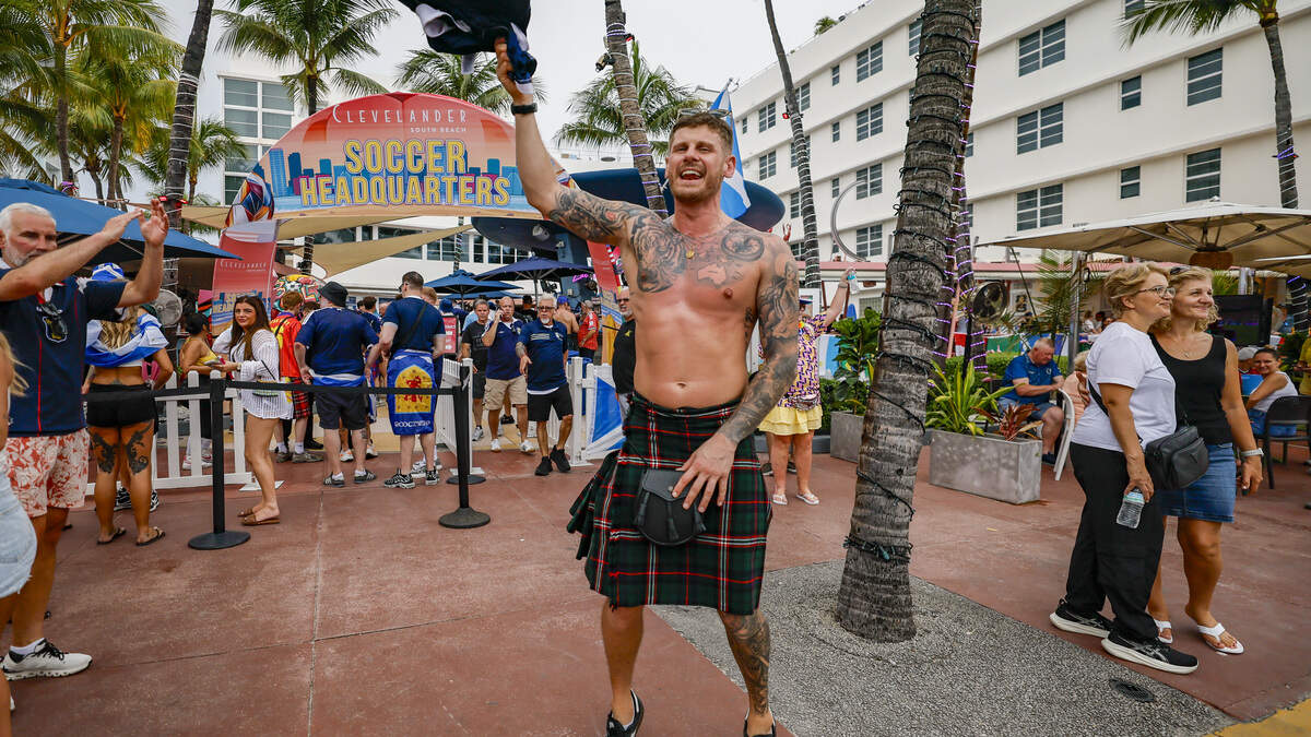 Scotland national football fan Kyle Tait jumps in front of The Clevelander as The Tartan Army parades along Ocean Drive on Miami Beach, Tuesday, June 23, 2026. Scotland national football fan Kyle Tait jumps in front of The Clevelander as The Tartan Army parades along Ocean Drive on Miami Beach, Tuesday, June 23, 2026.